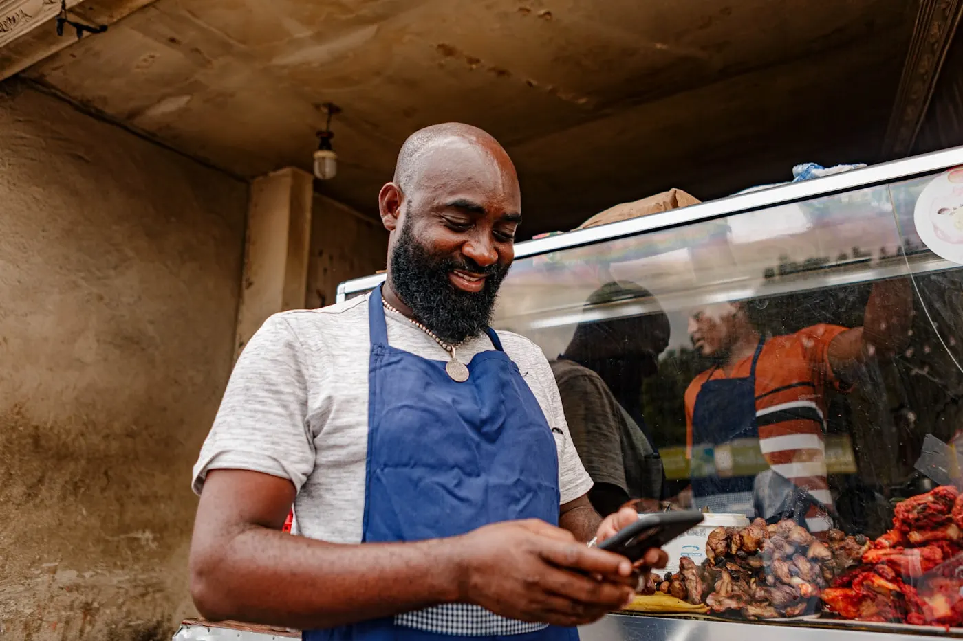 Small business owner checking orders on a phone